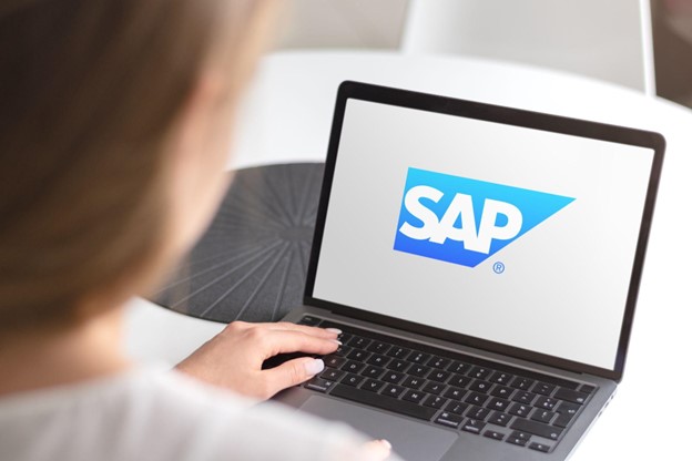 An image of a woman at a laptop googling SAP in search of the answer to what is SAP experience.